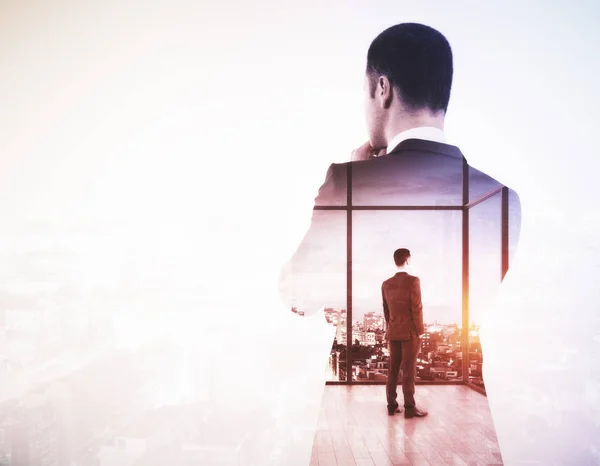 Back view of young businessman looking into the distance on light city background with copy space. Research concept. Double exposure — Stock Photo, Image