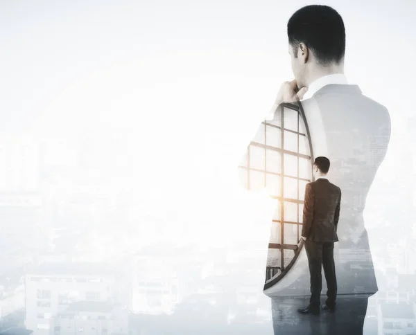 Back view of young businessman looking into the distance on light city background with copy space. Future concept. Double exposure — Stock Photo, Image