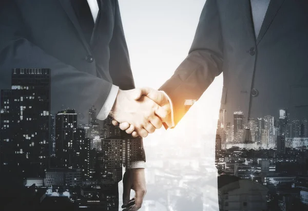 Businessmen shaking hands on night city background. Double exposure. Teamwork concept — Stock Photo, Image