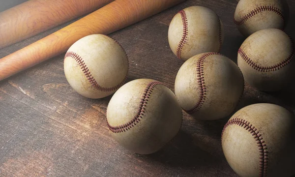 Numerous balls and bats on wooden desk — Stock Photo, Image