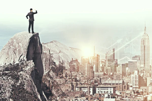 Back view of young businessman on mountain top looking into the distance. — Stock Photo, Image