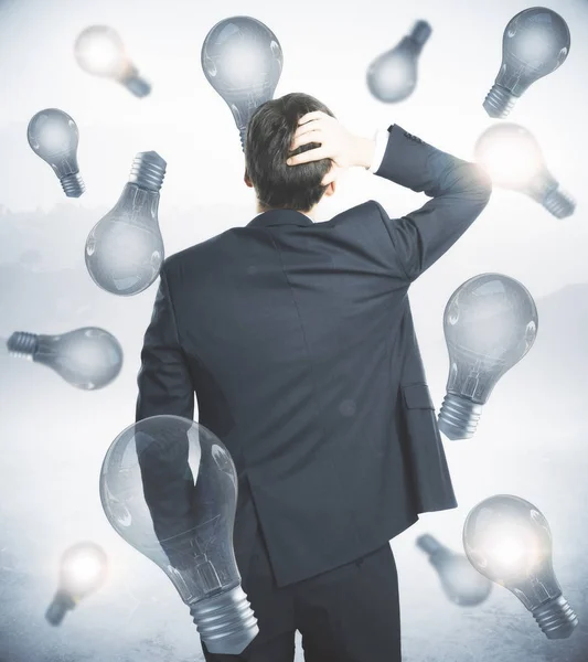 Worried businessman on lamp background — Stock Photo, Image