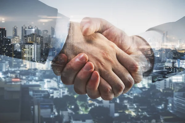 Side view and close up of professional handshake on abstract modern downtown city background. Union concept. Double exposure — Stock Photo, Image
