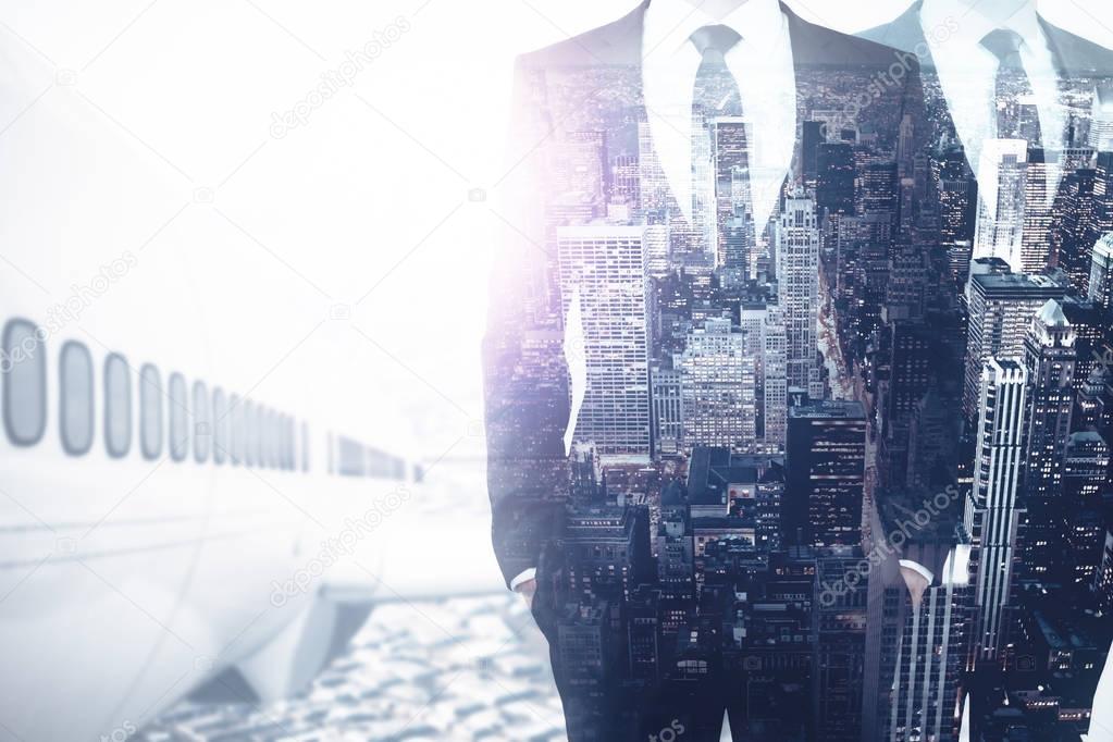 Businessman with large airplane standing on abstract city background. Vacation concept. Double exposure 