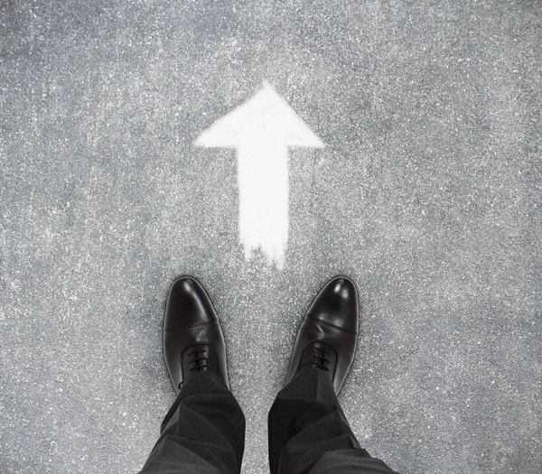 stock image Top view of businessmen feet on concrete floor with drawn arrow. Hope concept 