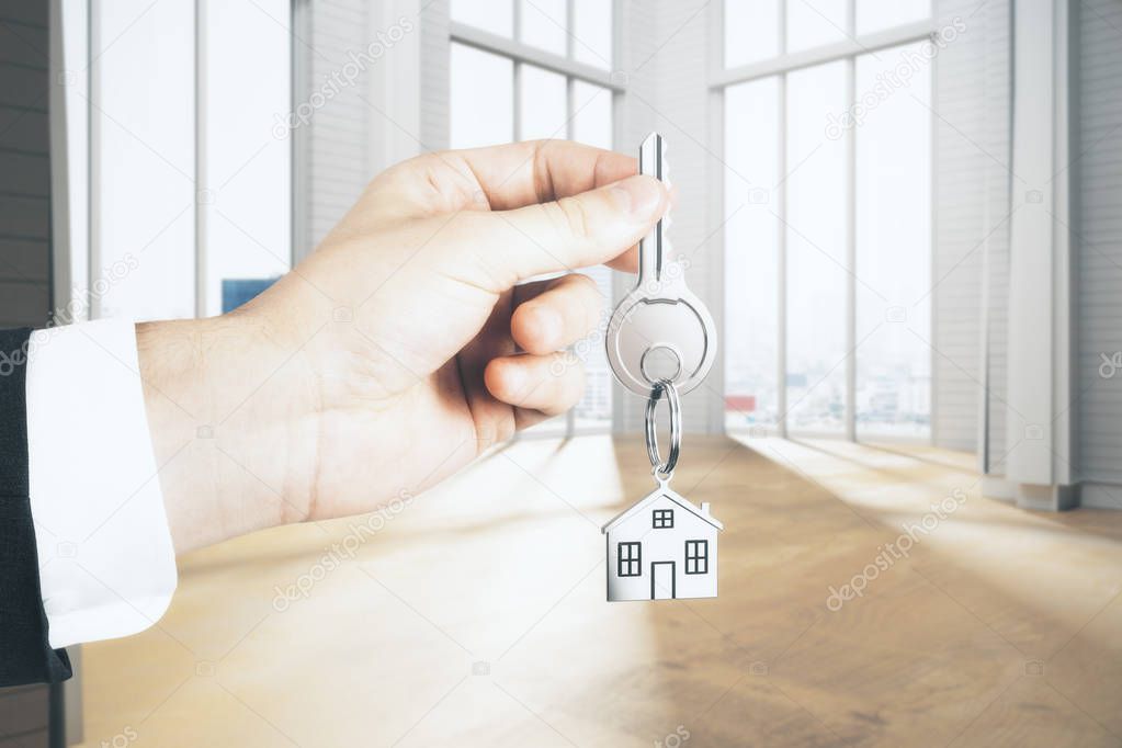 Businessman hand holding key