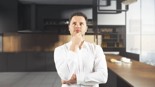 Thoughtful man in blurry kitchen — Stock Photo, Image