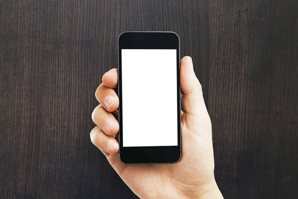 Мужская рука держит пустой белый телефон — стоковое фото