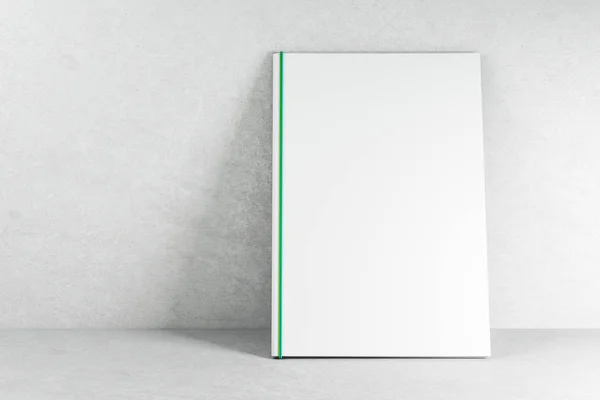 Libro blanco vacío sobre papel pintado de hormigón —  Fotos de Stock