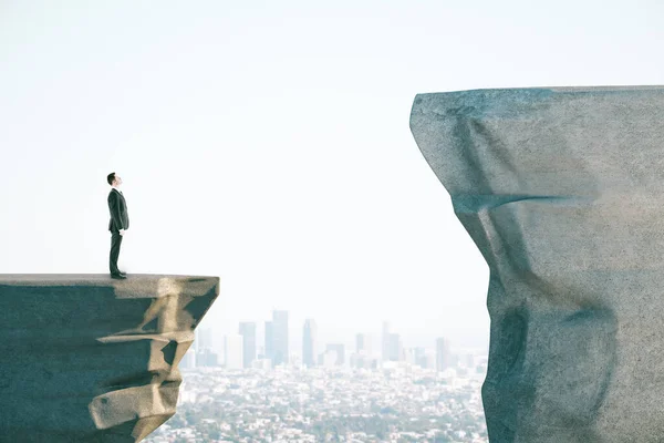 Businessman in suit on cliff — 스톡 사진