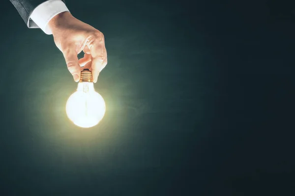 Businessman hand holding glowing bulb — Stock Photo, Image