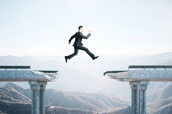 Businessman jumping over the gap in the bridge — 스톡 사진