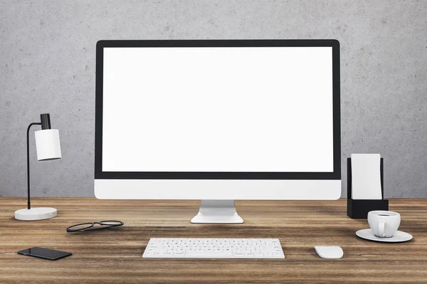 Office with blank computer screen and supplies — Stok fotoğraf