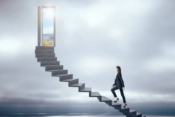 Businesswoman walking on ladder to success — 스톡 사진