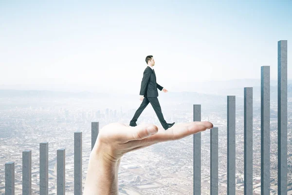 Hand helps a businessman climb on a business char — Stok fotoğraf