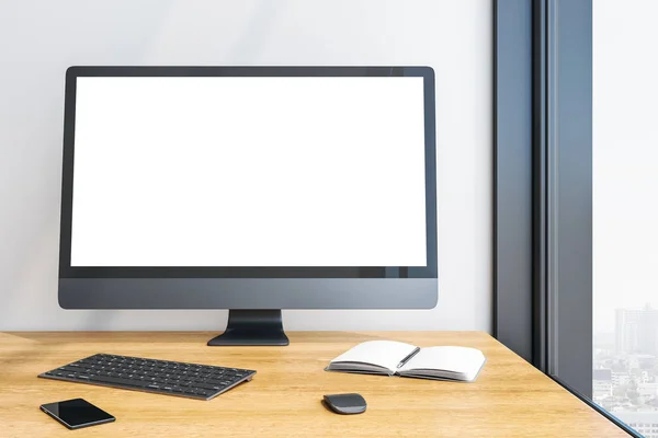 Designer desktop with empty white computer screen