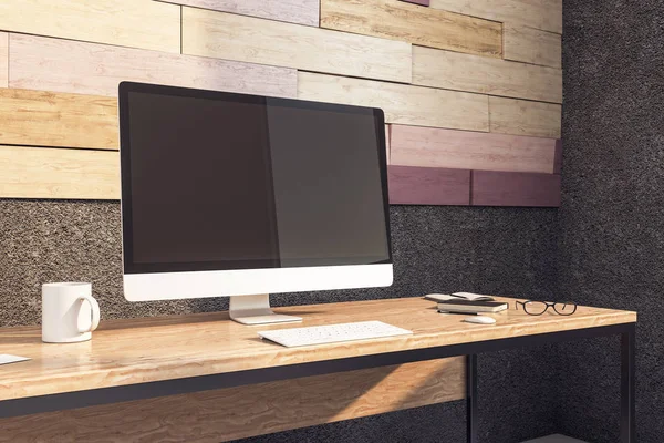 Blank black computer monitor on wooden table — Zdjęcie stockowe