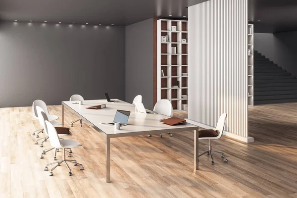 Minimalistic meeting room with laptops on table and blank wall. Workplace and company concept. 3D Rendering