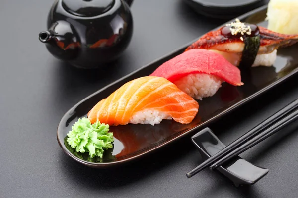 Tuna, salmon and eel sushi nigiri on the black table — Stock Photo, Image