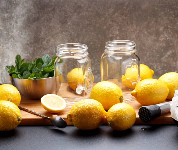 Fresh yellow lemon is ready for juicing on a black table — Stock Photo, Image