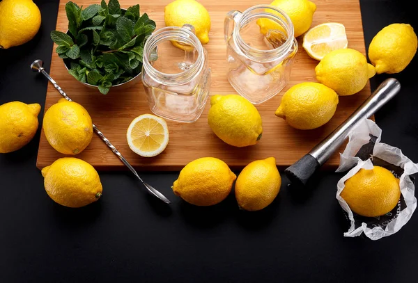 Fresh yellow lemon is ready for juicing on a black table — Stock Photo, Image