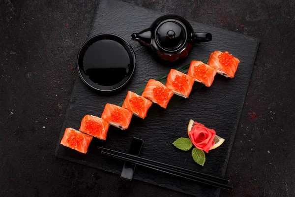 Japanese cuisine.  Sushi roll over concrete background.