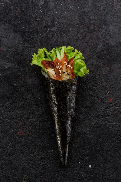 Eel handmade sushi (temaki) on a stone plate. — Stock Photo, Image