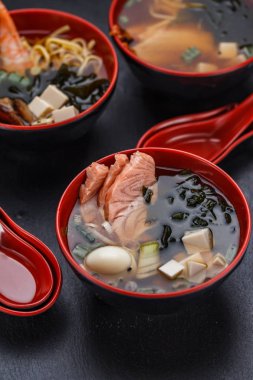 Ramen soup (set) over dark background/.