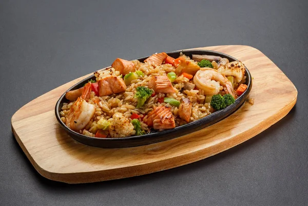 Рис с морепродуктами и овощами на темном фоне . — стоковое фото