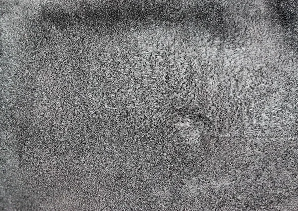 Texture of genuine leather. Suede leather texture closeup. Gray background.