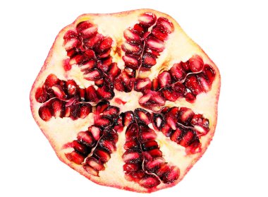 Pomegranate fruit cut in half on a white background