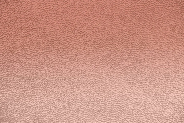 The texture of genuine leather. Pink background.