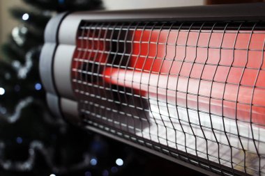 Infrared heater in the house. Warm light. Incandescent lamp. clipart