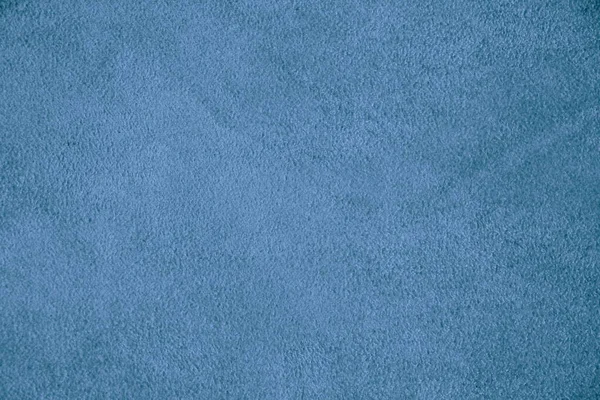 Texture of genuine leather. Suede leather texture closeup. Blue background.