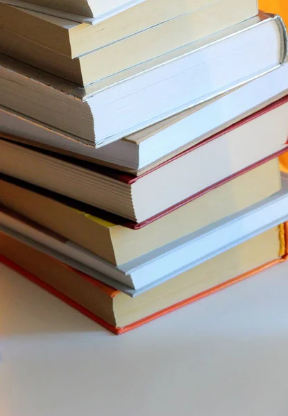 Close-up paper books and different colored covers.