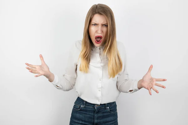 stock image young beatuiful blond angry woman looks furious standing on isolated white background, splash of emotions