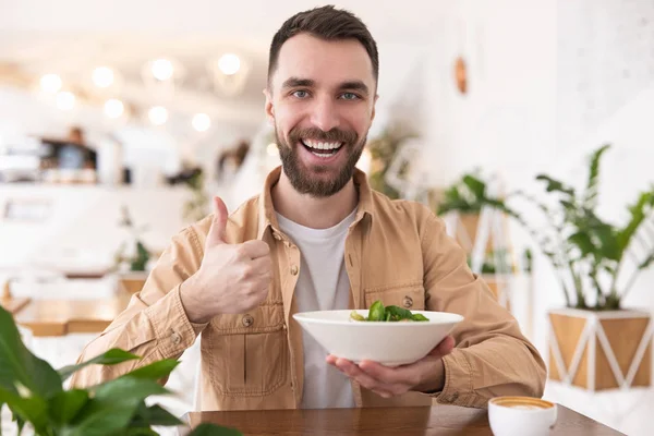 Young Bearded Man Holding Plate Salad One Hand Shows While — Stock Photo, Image