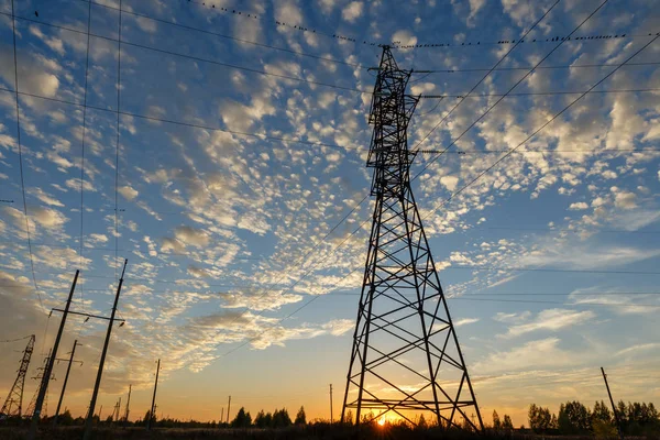 High voltage power line supports at sunset