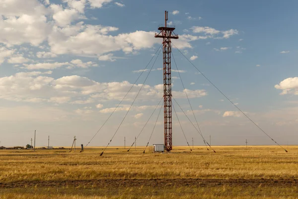 Iron Cell Tower with steel cables in the steppe — Stock Photo, Image