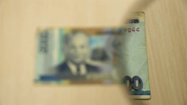 Ver Billete Dos Mil Lao Kip Acostado Una Mesa Con — Vídeos de Stock