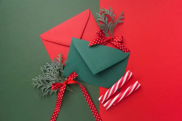 Red and green envelopes on christmas holiday background. Flat lay. — Stock Photo, Image