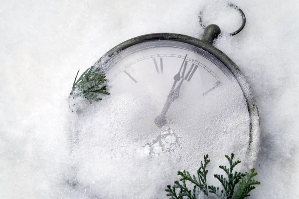 Watch lying in the snow before the new year — Stock Photo, Image