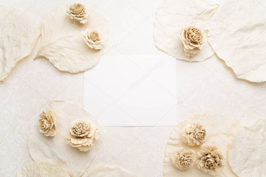 Framework with dry flowers on white background. Flat lay