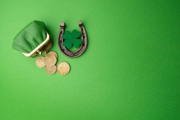 St. Patricks day, lucky charms. Horesechoe and shamrock on green background