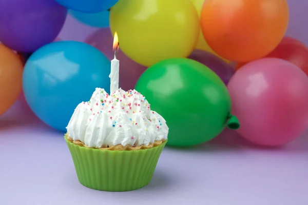 Cupcake με πολύχρωμους γενέθλια κερί και μπαλόνια — Φωτογραφία Αρχείου