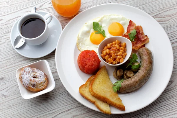 Traditionele compleet Engels ontbijt - sunny-side-up gebakken eieren, worst, bonen, champignons en spek — Stockfoto