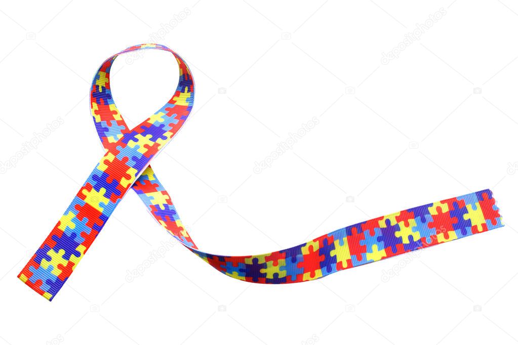 World Autism awareness and pride day with Puzzle pattern ribbon isolated on white