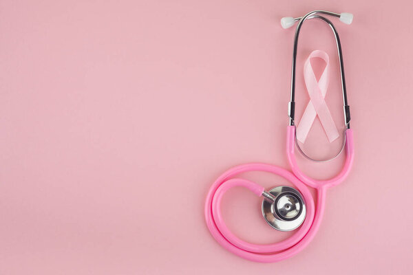 Pink ribbon and stethoscope on pink background, Symbol of breast cancer in women, Health care concept