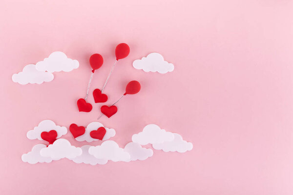 Valentines day background. Red hearts, baloons and clouds on soft pink background feel like fluffy in the air