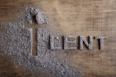 Lent word written in ash, dust as fast and abstinence period concept. Top view clipart